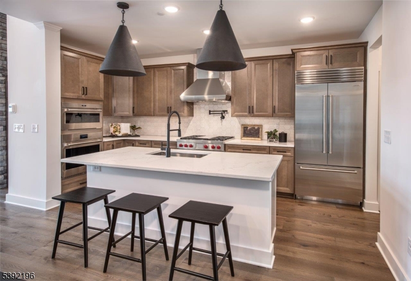 20 Whitaker Lane Far Hills, NJ 07931 - Photo 7 of 18 a kitchen with stainless steel appliances a sink a stove and a refrigerator