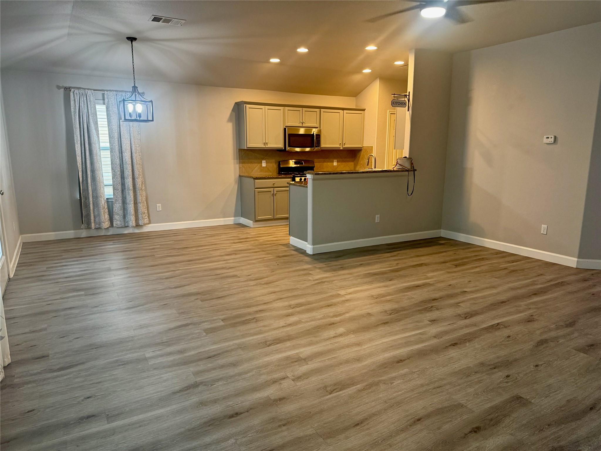 315 Nottingham Loop Kyle, TX 78640 - Photo 16 of 16 An open floorplan seamlessly connects the well-appointed kitchen with an inviting living space.