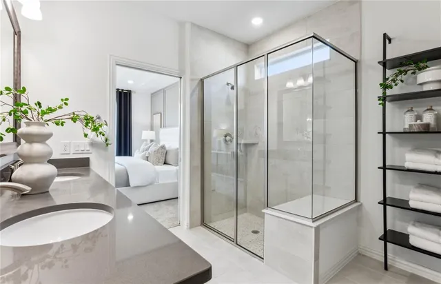 a bathroom with a shower sink and mirror