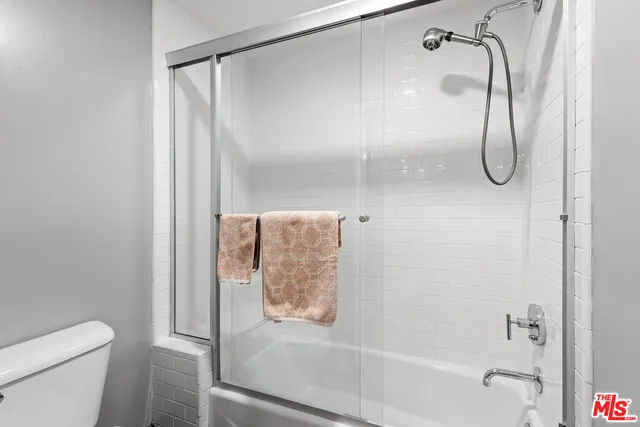 a bathroom with a glass shower door