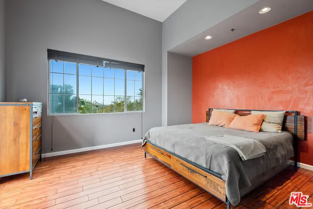 a bedroom with a bed and window