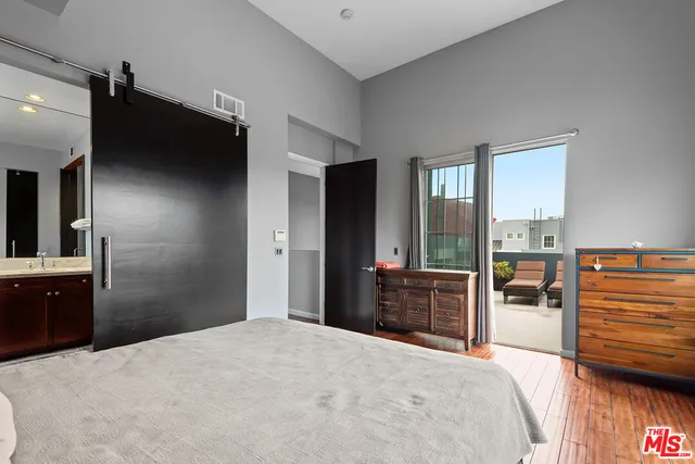 a bathroom with a granite countertop double vanity sink and mirror