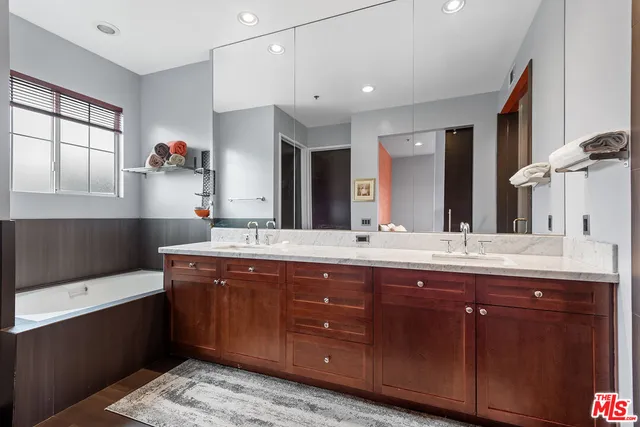a bathroom with a sink double vanity and a large mirror