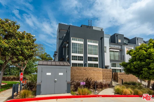 a front view of a building with garden