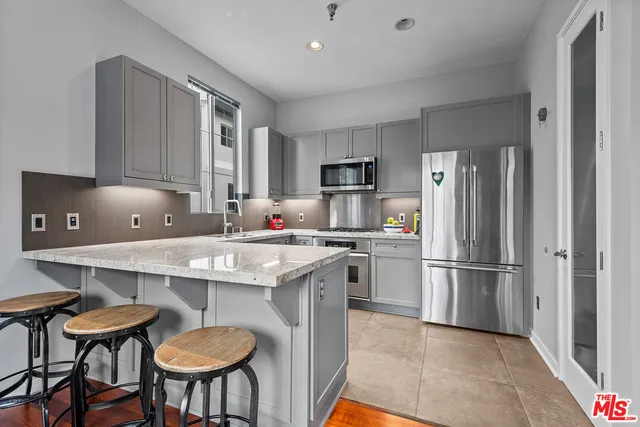a kitchen with refrigerator cabinets and chairs