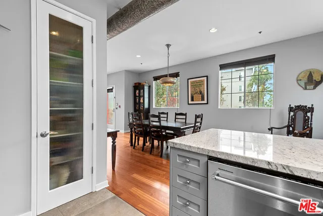 a kitchen with granite countertop a stove and cabinets