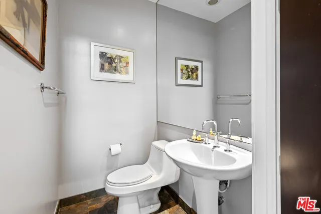 a bathroom with a sink toilet and a mirror