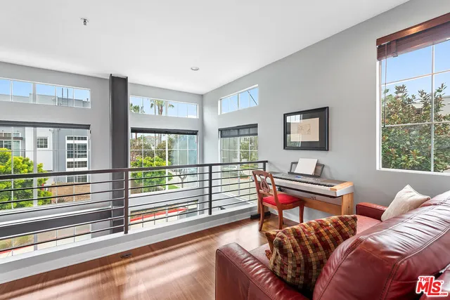 a living room with furniture a large window and a flat screen tv