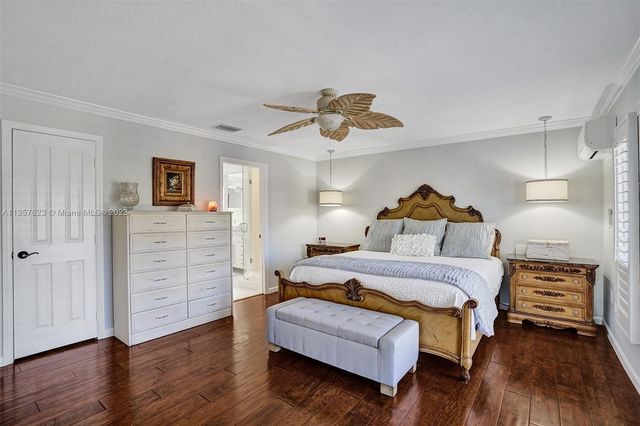 a bedroom with furniture and wooden floor