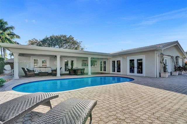 a view of a house with swimming pool and porch