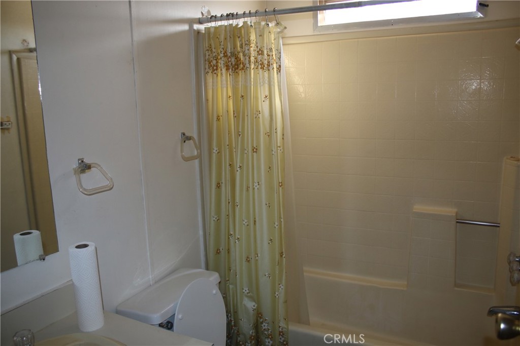 1147 Cherokee Trail Yucca Valley, CA 92284 - Photo 11 of 27 a bathroom with a shower and toilet