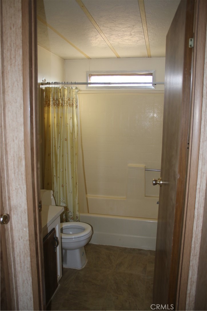 1147 Cherokee Trail Yucca Valley, CA 92284 - Photo 12 of 27 a bathroom with a shower and a toilet