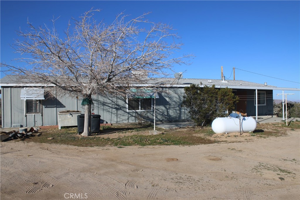 1147 Cherokee Trail Yucca Valley, CA 92284 - Photo 18 of 27 a house with trees in front of it