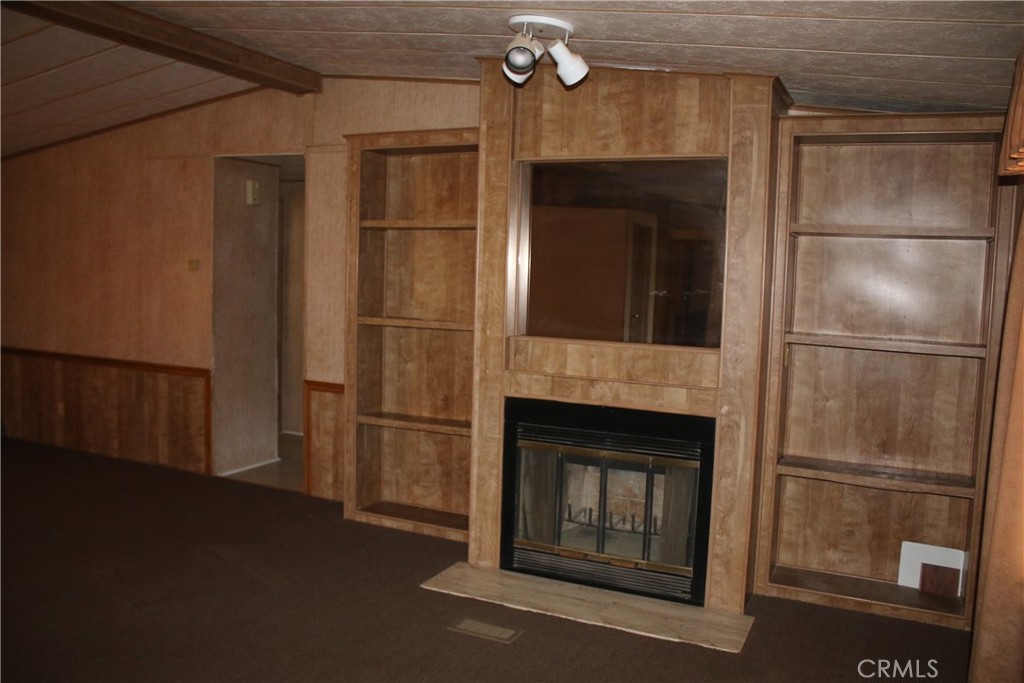 1147 Cherokee Trail Yucca Valley, CA 92284 - Photo 22 of 27 a kitchen with a refrigerator and wooden floor