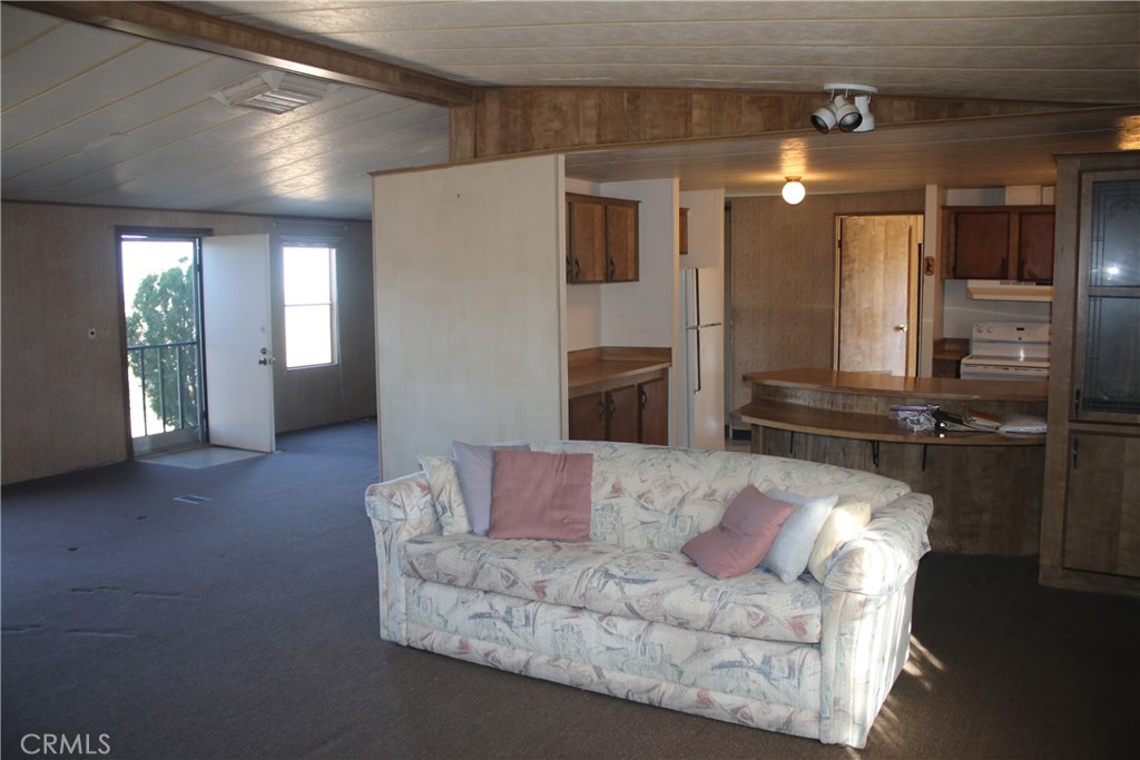 1147 Cherokee Trail Yucca Valley, CA 92284 - Photo 4 of 27 a living room with furniture and a fireplace