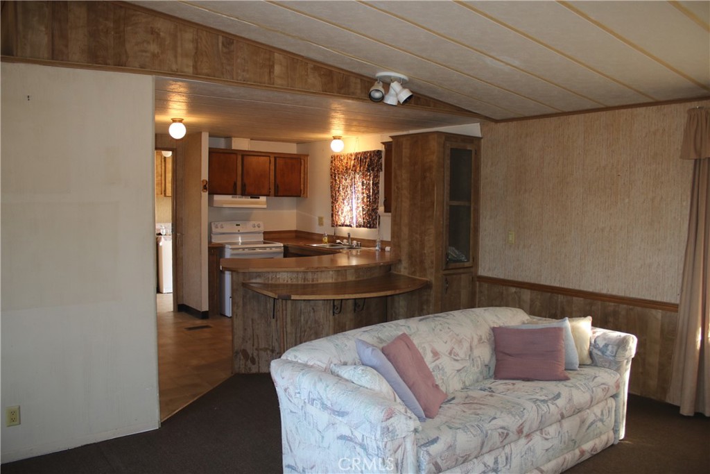 1147 Cherokee Trail Yucca Valley, CA 92284 - Photo 5 of 27 a kitchen with a refrigerator and a sink