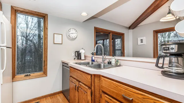 a bedroom with a bed and a lamp on dresser