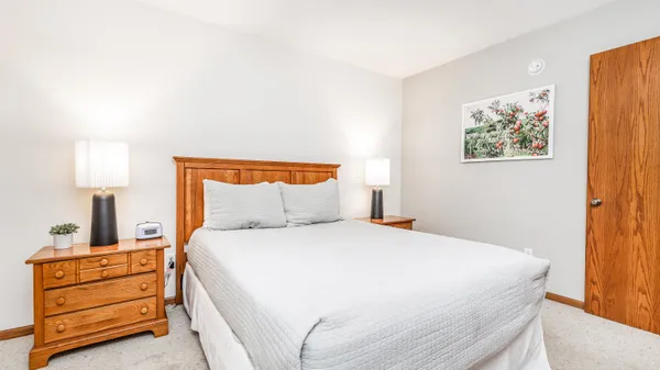 a bedroom with a bed and a dresser