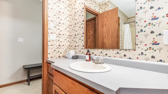a bathroom with a sink toilet and shower