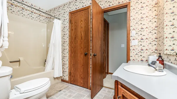 a bedroom with two beds and painting on the wall