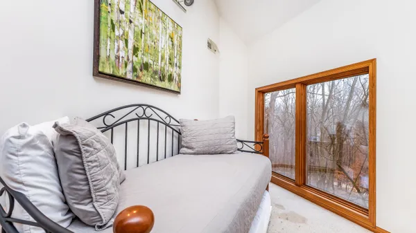 a bedroom with a bed and flat screen tv