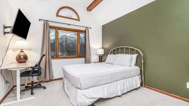 a bedroom with a bed and a dresser