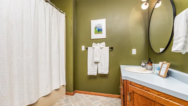 a bedroom with two beds and painting on the wall