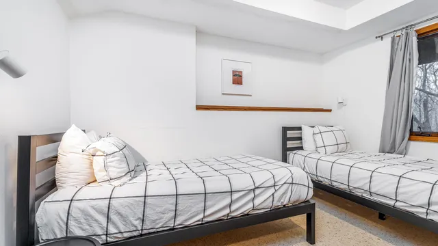 a bedroom with a bed and a window