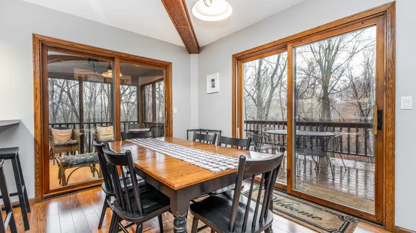 a dining room with furniture and wooden floor
