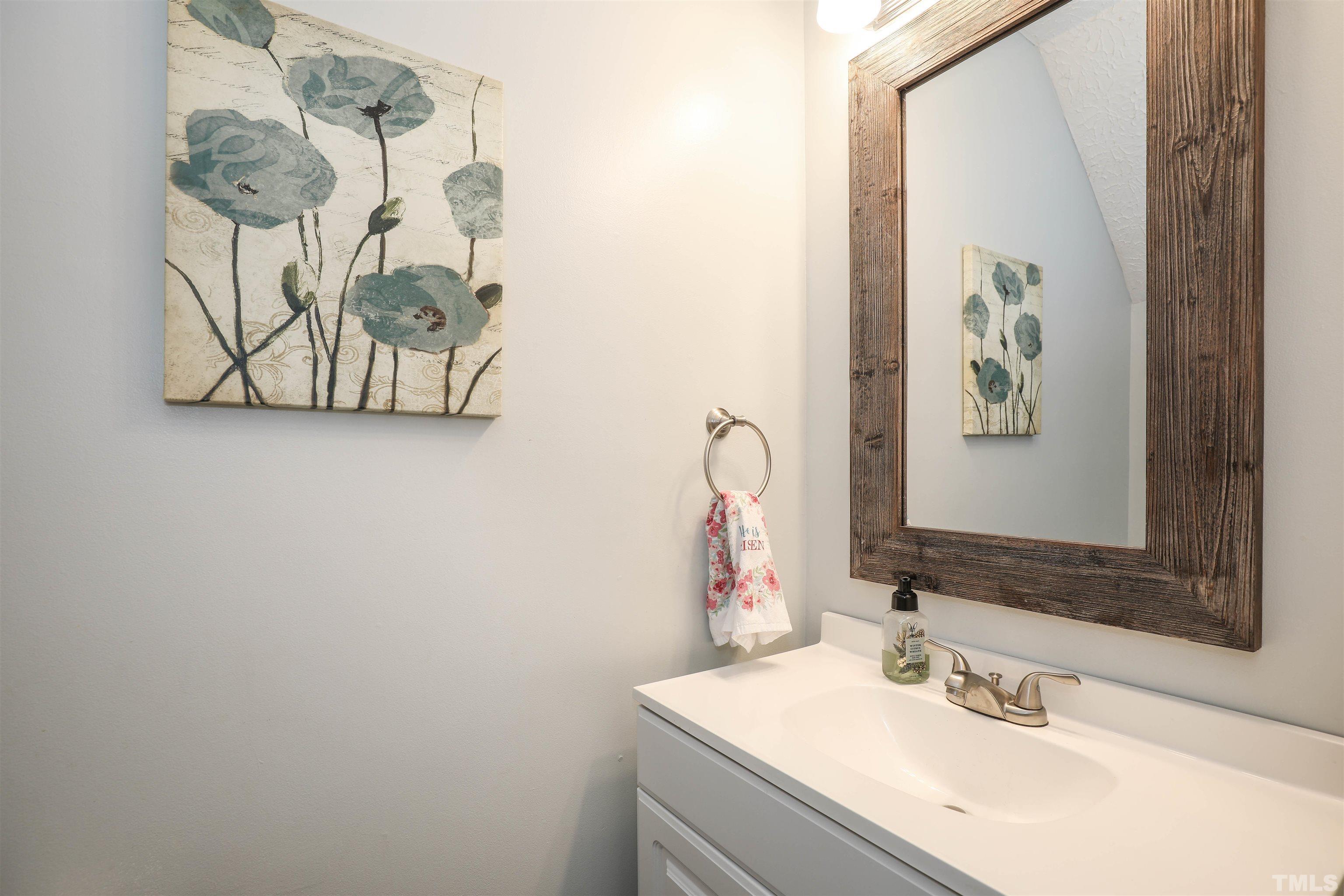 5805 Wynmore Road Raleigh, NC 27610 - Photo 14 of 20 a bathroom with a sink and a mirror