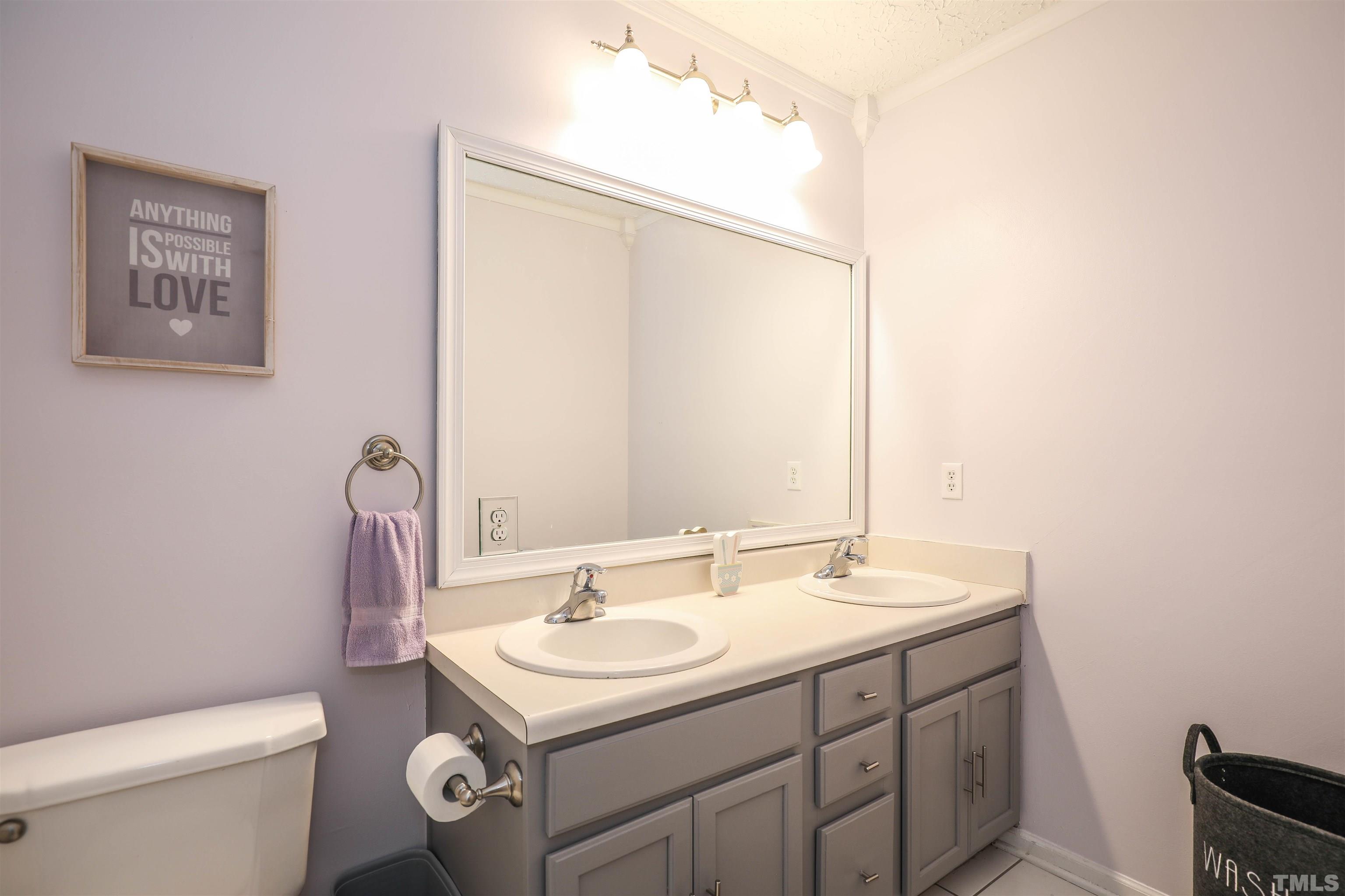 5805 Wynmore Road Raleigh, NC 27610 - Photo 16 of 20 a bathroom with a sink toilet and a mirror