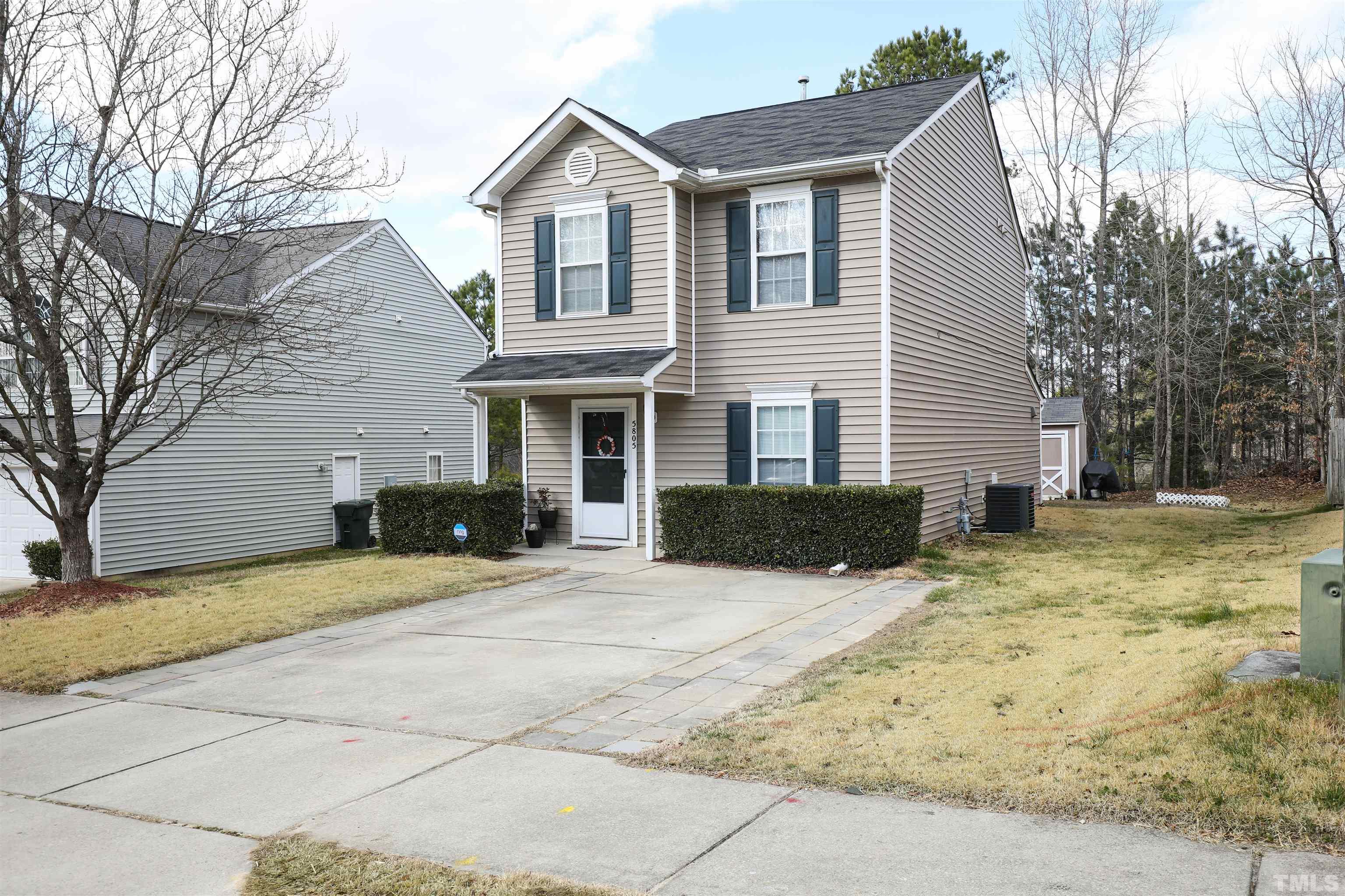 5805 Wynmore Road Raleigh, NC 27610 - Photo 2 of 20 a front view of a house with a yard covered with snow