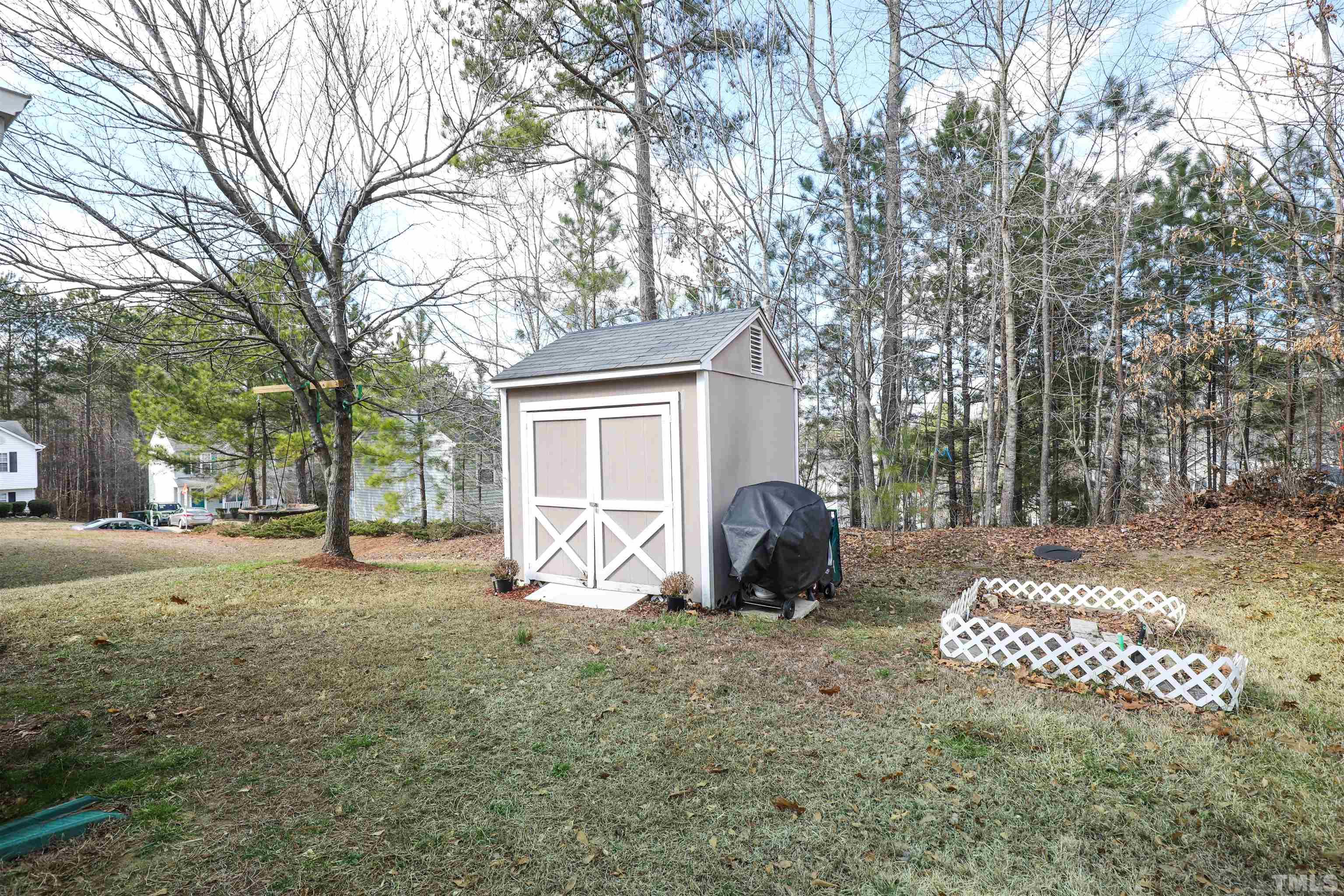 5805 Wynmore Road Raleigh, NC 27610 - Photo 3 of 20 a view of a house with backyard and a tree