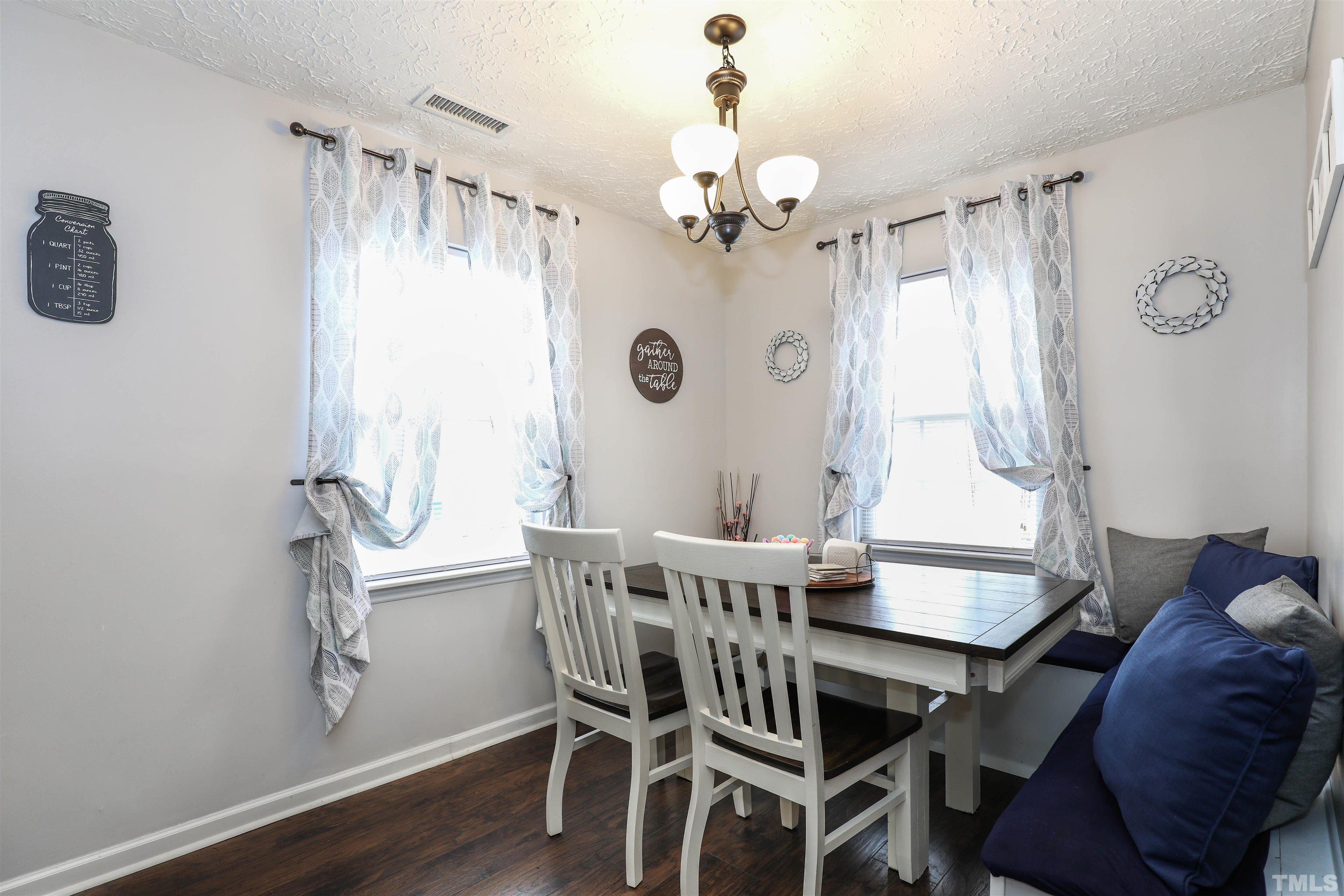 5805 Wynmore Road Raleigh, NC 27610 - Photo 8 of 20 a view of a dining room with furniture window and wooden floor