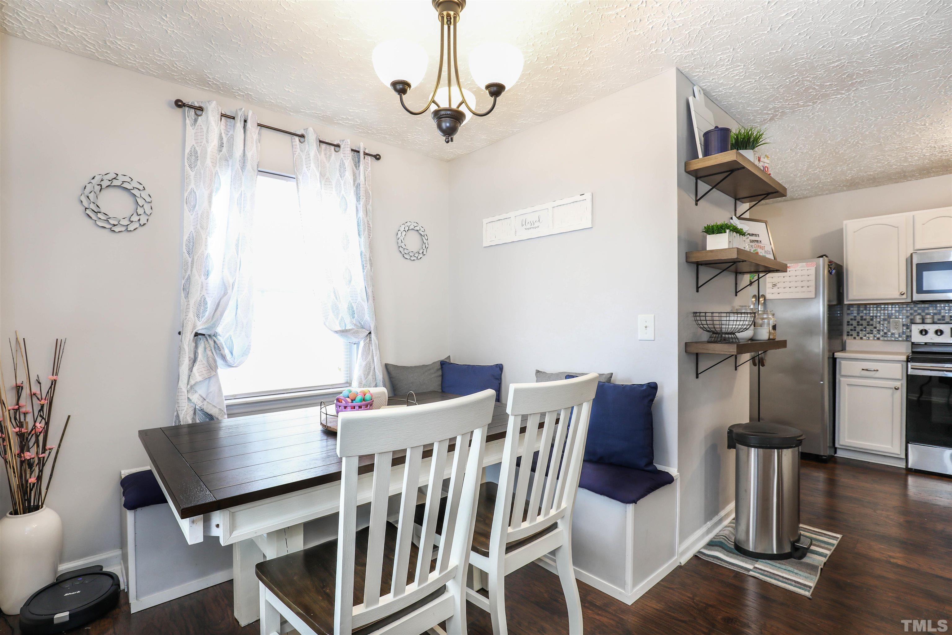 5805 Wynmore Road Raleigh, NC 27610 - Photo 9 of 20 a view of a dining room with furniture window and wooden floor