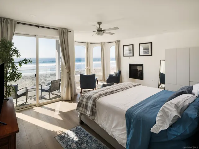 a bedroom with a large bed and a large window