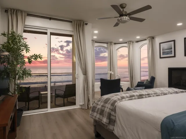 a bedroom with a bed and large window