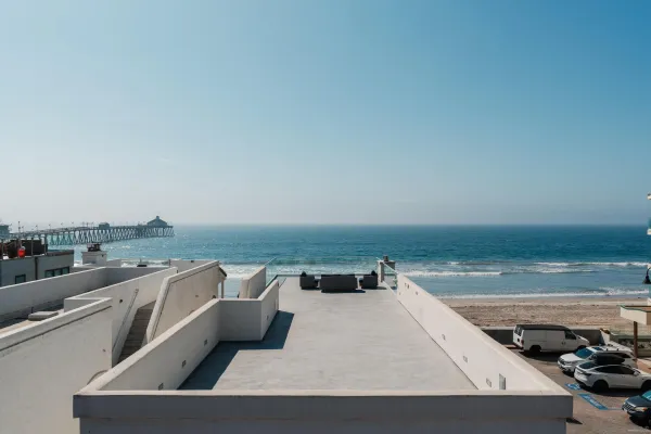 a roof deck with table and chairs a barbeque
