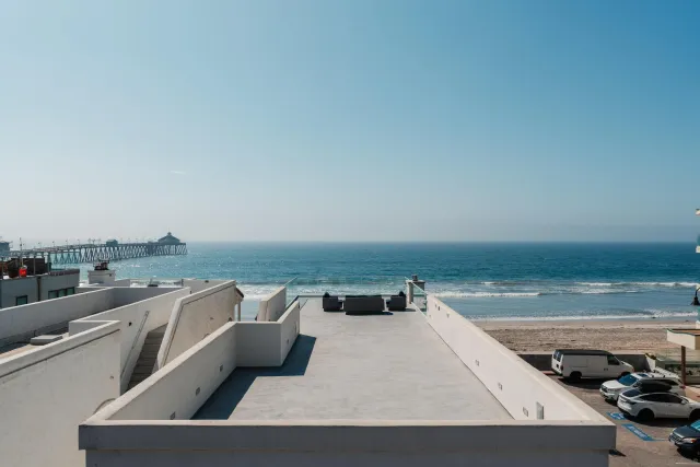 a roof deck with table and chairs a barbeque