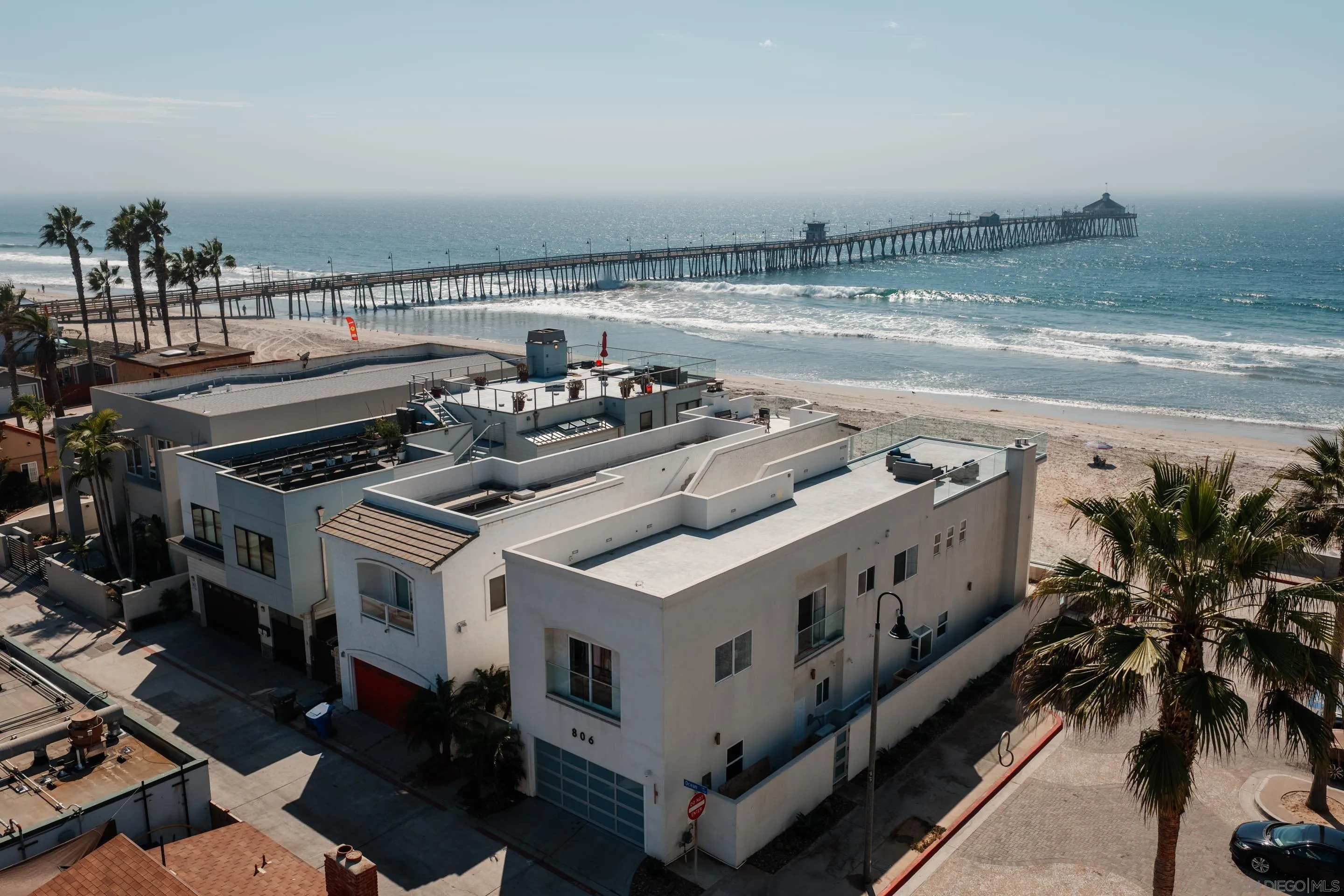 806 Ocean Lane Imperial Beach, CA 91932 - Photo 37 of 59 a roof deck with table and chairs a barbeque