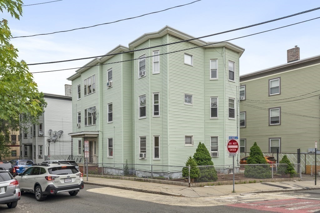 105 Walnut Street Somerville, MA 02145 - Photo 1 of 37 a view of a street that has couple of cars parked on the road
