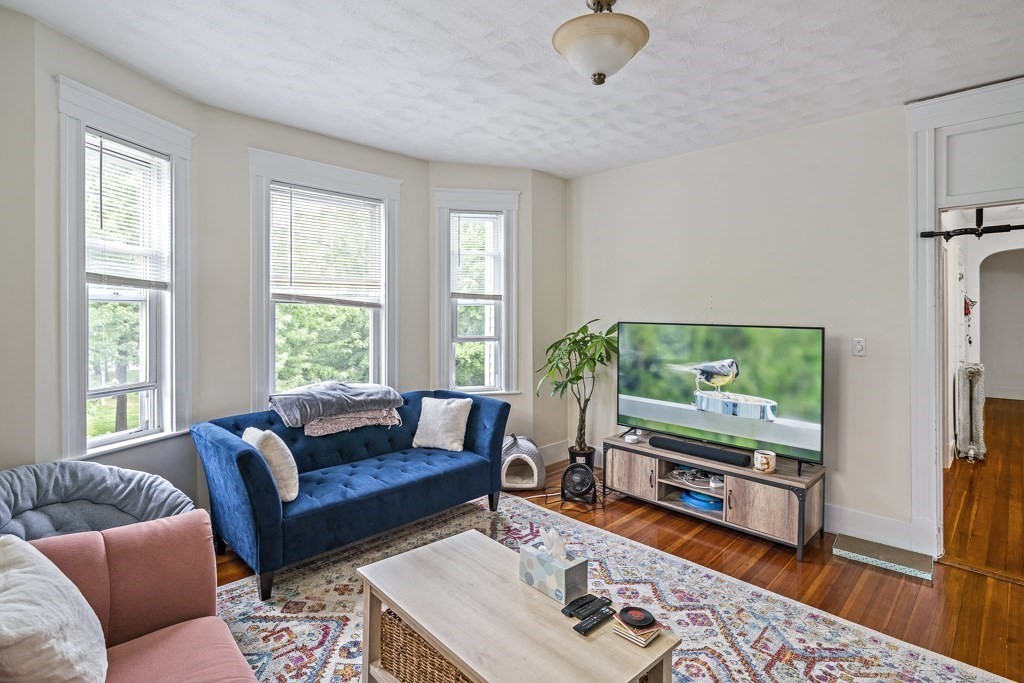 105 Walnut Street Somerville, MA 02145 - Photo 11 of 37 a living room with furniture and a flat screen tv