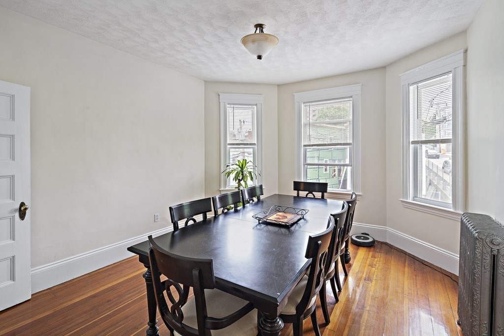 105 Walnut Street Somerville, MA 02145 - Photo 13 of 37 a view of a dining room with furniture window and wooden floor