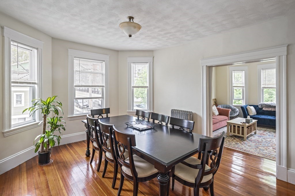 105 Walnut Street Somerville, MA 02145 - Photo 15 of 37 a view of a dining room with furniture window and wooden floor