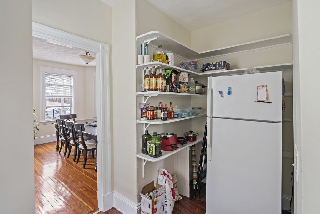105 Walnut Street Somerville, MA 02145 - Photo 16 of 37 a kitchen with a refrigerator and wooden floor