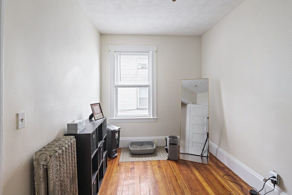 105 Walnut Street Somerville, MA 02145 - Photo 21 of 37 a room with furniture and a window