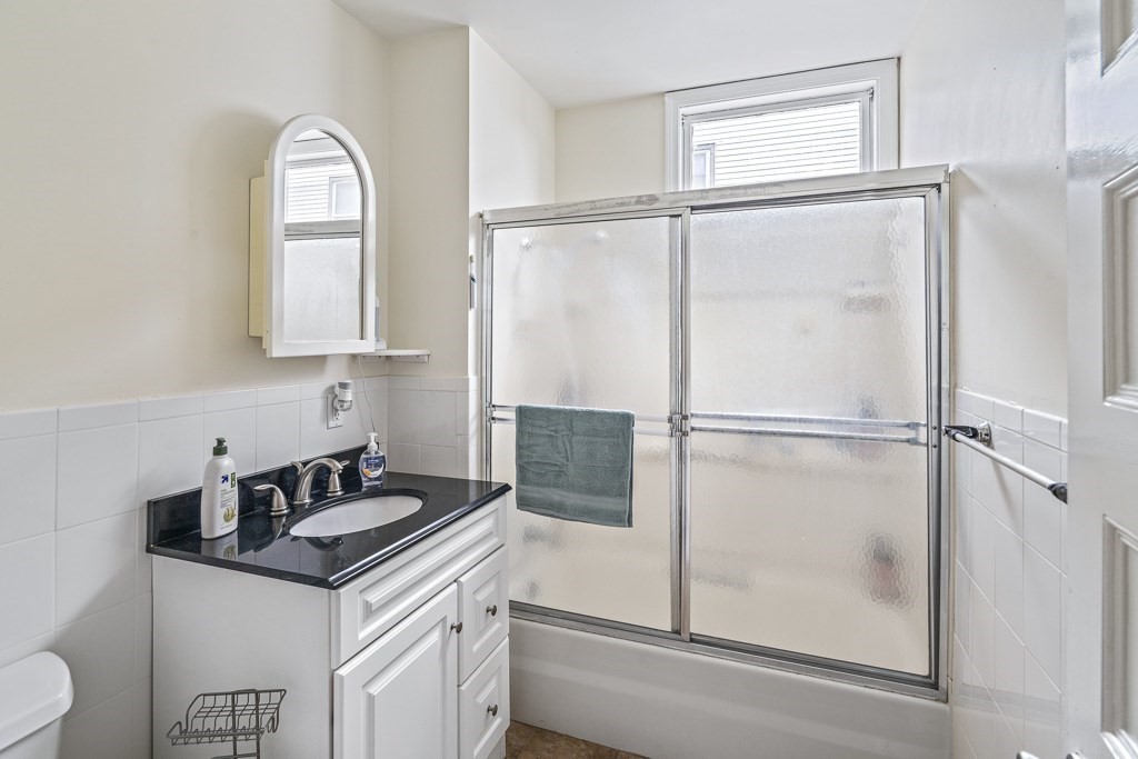 105 Walnut Street Somerville, MA 02145 - Photo 22 of 37 a kitchen with a refrigerator a sink and cabinets