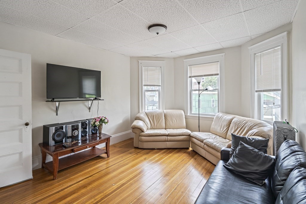 105 Walnut Street Somerville, MA 02145 - Photo 24 of 37 a living room with furniture and a flat screen tv