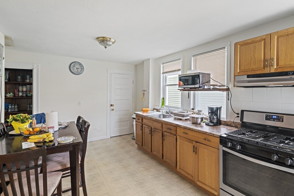 105 Walnut Street Somerville, MA 02145 - Photo 25 of 37 a kitchen with a stove and a sink