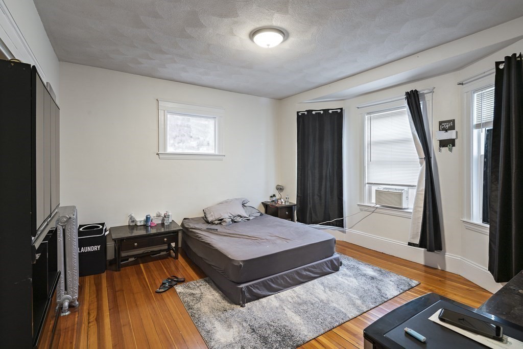 105 Walnut Street Somerville, MA 02145 - Photo 27 of 37 a living room with a bed and a table